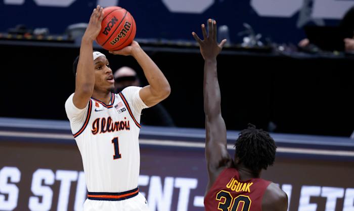 Illinois Fighting Illini guard Trent Frazier (1) takes a shot as Loyola (Il) Ramblers forward Aher Uguak (30) attempts a block during the second round of the 2021 NCAA Tournament on Sunday, March 21, 2021, at Bankers Life Fieldhouse in Indianapolis, Ind.